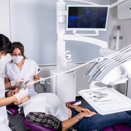 Klinikte iki hekimin hasta koltuğunda tedavi uygularken çekilmiş fotoğrafı